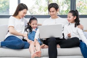 Young Asian family entertained at home in free time photo