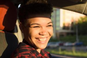 Happy and beautiful african american woman with short hair in a car, lifestyle
