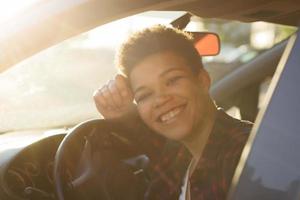 Beautiful African American woman with short hair in the car, lifestyle
