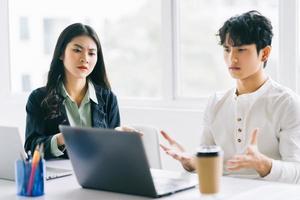 Two young Asian businessmen are debating the year-end project photo