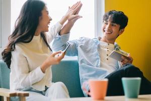 Asian couple playing games at home together, the happy life of a newlyweds photo