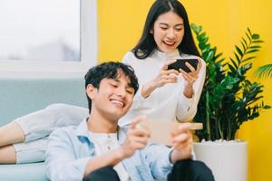 Asian couple playing games at home together, the happy life of a newlyweds photo