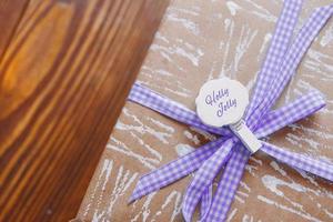 Gift box on wooden table. photo