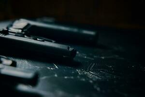 Three guns on black table. photo