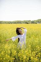 Young woman in the rapeseed field photo