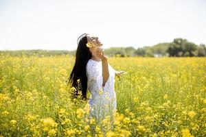 Young woman in the rapeseed field photo