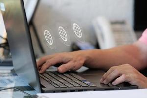 Businessman hand working on laptop computer and network and data connection , work from home concept, marketing plan concept photo
