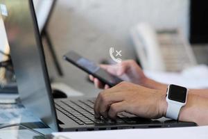 Businessman hand working on laptop computer and network and data connection , work from home concept, marketing plan concept photo