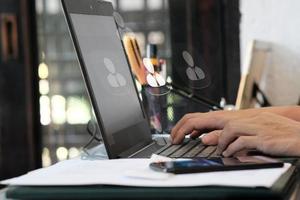 Businessman hand working on laptop computer and network and data connection , work from home concept, marketing plan concept photo