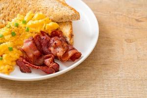 Scrambled egg with bread toasted and bacon for breakfast photo