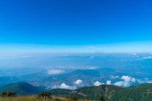 Beautiful mountain layer with clouds and blue sky at Kew Mae Pan Nature Trail in Chiang Mai, Thailand photo