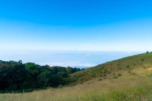 Beautiful mountain layer with clouds and blue sky at Kew Mae Pan Nature Trail in Chiang Mai, Thailand photo