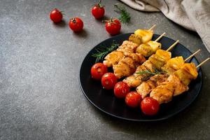 Grilled chicken barbecue skewer on plate photo