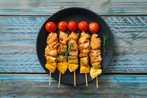 Grilled chicken barbecue skewer on plate photo