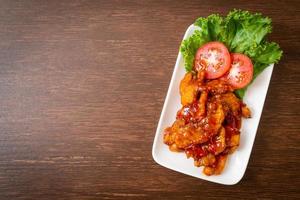 Fried fish topped with 3 flavors, sweet, sour, and spicy chili sauce photo
