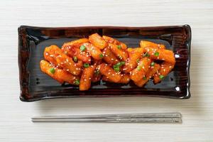 Deep-fried Korean rice cake, or Tteokbokki, skewered with spicy sauce - Korean food style photo