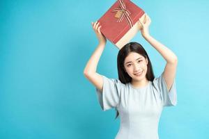 Asian woman holding gift box photo