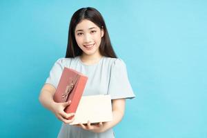 Asian woman holding gift boxes photo