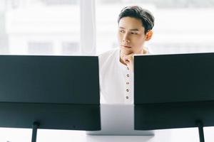 Asian programmer focusing on his work photo