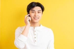 Asian man on a yellow background photo