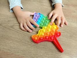 A child plays with a pop it toy photo