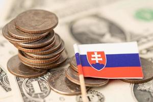 Stack of coins with Slovakia flag on US dollar banknotes background. photo