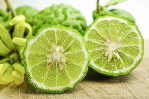 Bergamot fresh fruit on wooden background, healthy plant for body and hair. photo