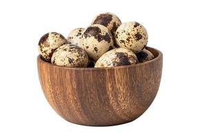 Quail eggs in wooden bowl isolated on white background with clipping path. photo