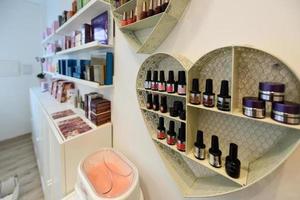 Cosmetic section with nail polish, facial cream, conditioners, shampoo and hair treatment photo