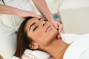 Woman receiving head massage in spa wellness center. photo