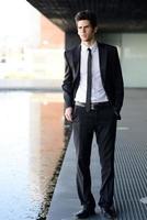 Attractive young businessman in urban background photo