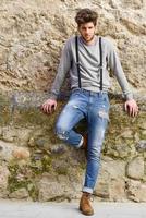 Man wearing suspenders in urban background photo