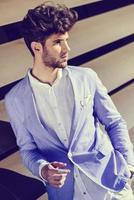 Attractive young handsome man, model of fashion in urban background photo