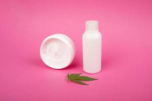 body care, anti-aging skin care cosmetics with marijuana extract on a pink background photo