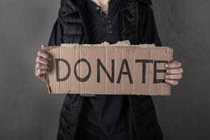 woman asks for help with donation sign photo