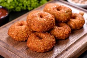 Beautiful delicious fresh chickpea falafel with sauces on a concrete background photo