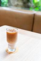 Iced latte coffee glass in coffee shop cafe and restaurant photo