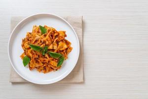 Farfalle pasta with basil and garlic in tomato sauce - Italian sauce photo