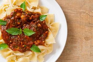 Farfalle pasta with basil and garlic in tomato sauce - Italian sauce photo