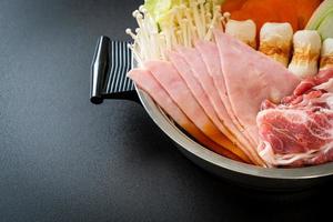 Sukiyaki or shabu hot pot black soup with meat raw and vegetable - Japanese food style photo