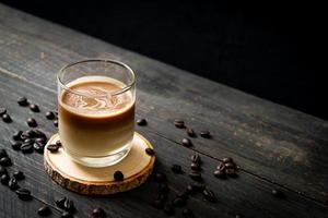 Glass of latte coffee, coffee with milk on wood background photo