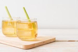 Iced lemon grass juice on wood background photo