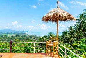 Empty chair on balcony with ocean sea viewpoint background in Thailand photo