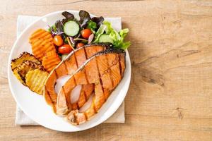 Double grilled salmon steak fillet with vegetables photo