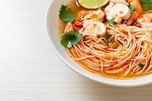 Noodles with spicy soup and shrimps or Tom Yum Kung - Asian food style photo