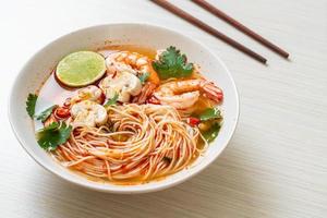 Noodles with spicy soup and shrimps or Tom Yum Kung - Asian food style photo