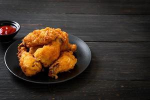 Fried chicken wings with ketchup - unhealthy food photo