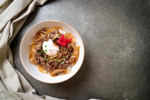 Beef sliced on topped rice with egg, or gyudon - Japanese food style photo