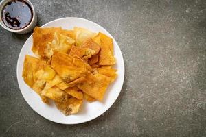 Deep-fried pork wonton with dipping sauce photo