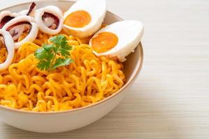 Instant noodles salt egg flavor with squid or octopus bowl photo